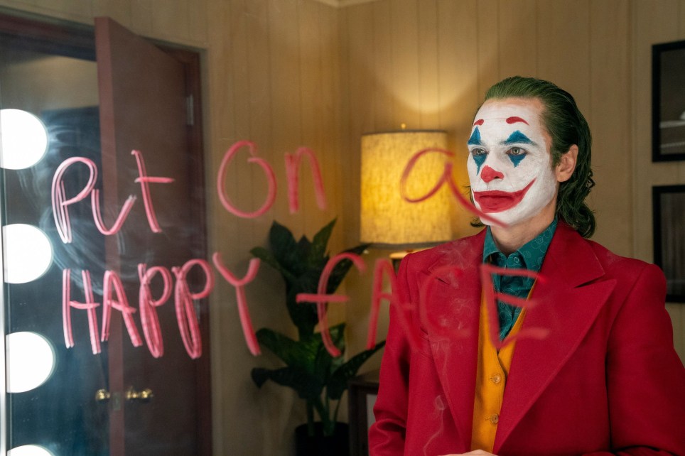 Joker looking himself at the mirror.