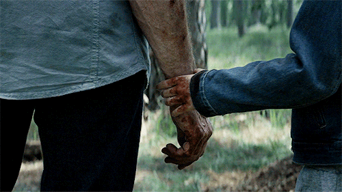 Laura holds Logan's hand
